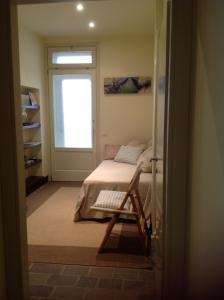 a small bedroom with a bed and a window at Casa Poli in Ravenna