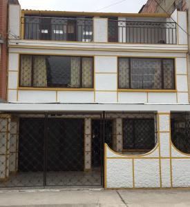 un edificio antiguo con ventanas y una valla en Hotel Don Olivo, en Bogotá