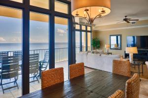 a dining room with a view of the ocean at Phoenix West II Unit 1109 in Orange Beach