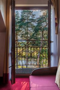 an open door to a balcony with a view of trees at Hotel *** Rancho Lot in Nowy Targ
