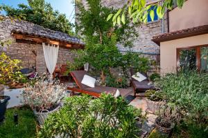 a backyard with a patio furniture and plants at Villa Carera old town of Rovinj-Rovigno in Rovinj