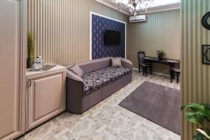 a living room with a couch and a table at L.O.Y Family Hotel in Dnipro