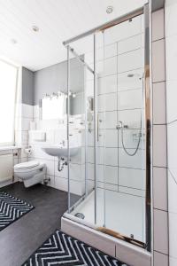 a bathroom with a shower and a toilet and a sink at Gasthaus zur Linde in Braunweiler +13 photos