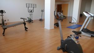 a gym with several treadmills and exercise bikes at T2LikeHome - São Martinho do Porto in São Martinho do Porto