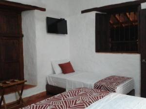 La Loma Hotel Barichara tesisinde bir odada yatak veya yataklar