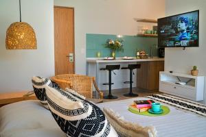 een woonkamer met een bank en een tv bij Arrecife Studios I Prime Location Steps to the Beach in Playa del Carmen