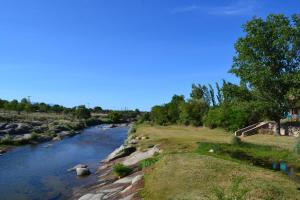 a river with rocks and trees on the side at Cabañas Los Álamos Panaholma in Panaholma