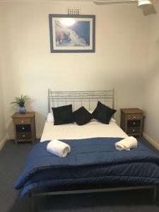 A bed or beds in a room at Tin Can Bay Budget Accommodation