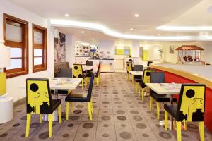 A seating area at KIMAYA Braga Bandung by HARRIS