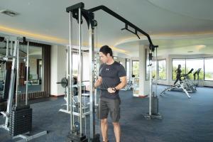 a man in a gym working out in a gym at Grand Kecubung Hotel in Pangkalan Bun