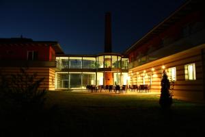 a building at night with a group of tables at Hotel Kelep in Tokaj