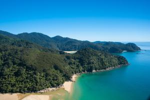
a large body of water with mountains at Abel Tasman Lodge in Marahau
