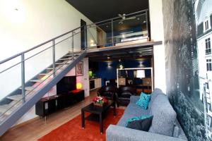 a living room with a couch and a staircase at Alojamiento ciudad las artes in Valencia