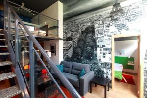 a living room with a wall mural of a building at Alojamiento ciudad las artes in Valencia