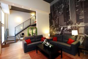 a living room with a couch and a staircase at Alojamiento ciudad las artes in Valencia