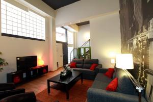 a living room with two couches and a tv at Alojamiento ciudad las artes in Valencia