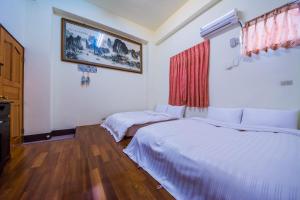 Cama o camas de una habitación en Happy Garden Homestay