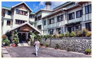 a man walking in front of a building at Zone Connect by The Park Mount Siniolchu, Gangtok in Gangtok