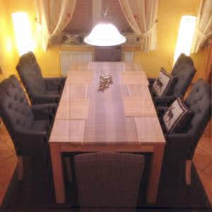 a dining room table with two chairs and a lightenment at Ferienhaus 2 Am Eichenberg in Blankenburg