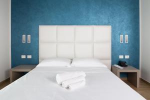 a white bed with two towels on top of it at Hotel Al Veliero in Pontevico