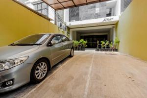 a silver car parked in front of a building at RedDoorz Plus @ Pasar Baru in Jakarta