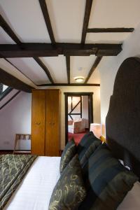 a bedroom with a bed and a chair at Prince Rupert Hotel in Shrewsbury
