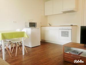 a small kitchen with a table and a microwave at Apartment Bruneck Central in Brunico