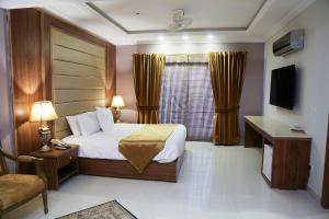 a hotel room with a bed and a window at Grace Boutique Hotel in Islamabad