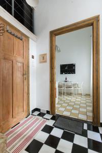 a door leading to a dining room with a table at Kazinczy 10 Apartment in Budapest