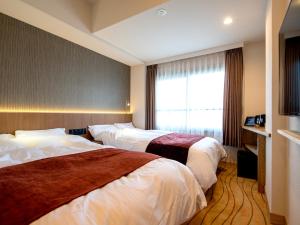 A bed or beds in a room at TKP Lectore Atami Momoyama