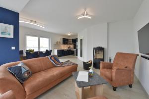 a living room with a couch and a chair at Ferienhaus Ausguck in Breege