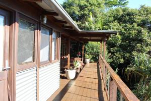 a porch of a house with potted plants on it at Byron Bay Accom 194 Balraith Lane Ewingsdale - Harika in Ewingsdale