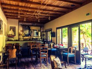 a dining room with tables and chairs in a room at Εποχές στη Βυζίτσα in Vyzitsa