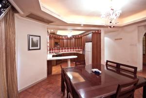 a dining room and kitchen with a table and chairs at فلل رويال ان in Jeddah +8 photos