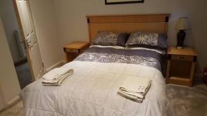 a bedroom with a bed with two towels on it at The Plough Inn in Little Dewchurch