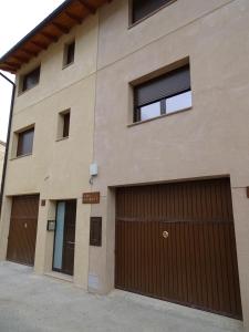 ein Gebäude mit zwei Garagentüren und Fenstern in der Unterkunft Casa Ombrieta in Beceite
