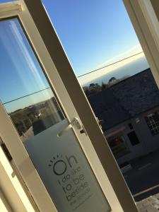 a sliding glass door with a sign on it at Waves - Duplex Apartment Stoke Fleming in Stoke Fleming