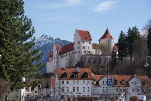 a large castle sitting on top of a mountain at Landhaus & Pension Christian in Füssen