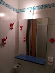 a bathroom with a mirror and a toilet with red handles at A Casa Di Silvy in Trieste +63 photos