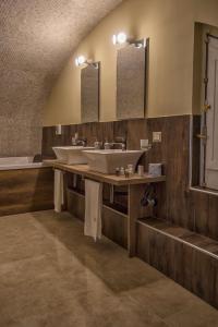 a bathroom with two sinks and two mirrors at Chiaia 205 in Naples