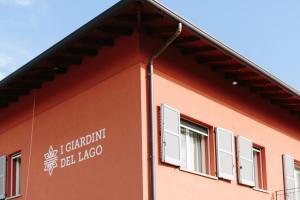 a building with a sign on the side of it at Agriturismo Familiare I Giardini del Lago in Varese