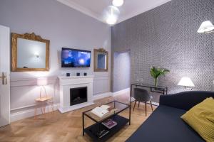 a living room with a couch and a fireplace at Grand Master Suites in Rome