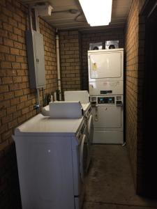 a kitchen with a stove and a refrigerator at Hudson Plaza Motel Bayonne Jersey City in Jersey City