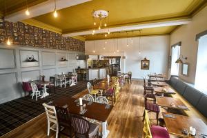 a dining room with wooden tables and chairs at The Commodore Inn in Grange Over Sands