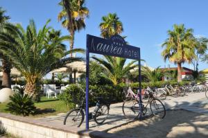 a street sign with bikes parked on a sidewalk at Aurea Hotel in Tortoreto Lido
