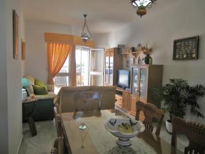 a living room with a couch and a table at Apartamento Pepi Chipiona in Chipiona