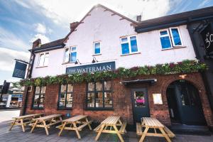 a brick building with benches outside of it at The Waterman in Cambridge