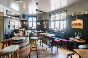 a restaurant with tables and chairs and a bar at The Waterman in Cambridge +16 photos