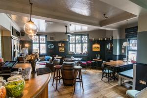a restaurant with tables and chairs and a bar at The Waterman in Cambridge