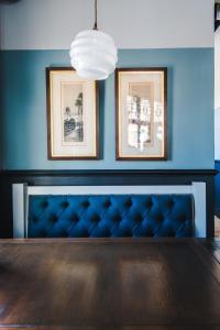 a dining room with a table and two framed pictures at The Waterman in Cambridge